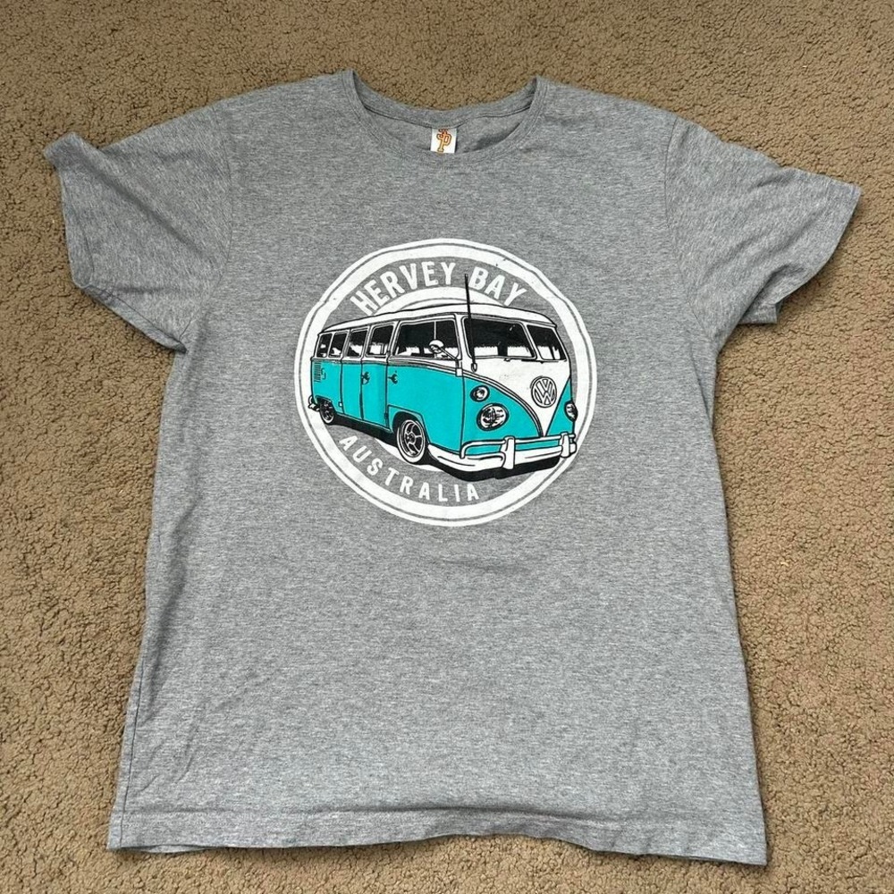 Vintage gray t-shirt featuring a graphic of a turquoise Volkswagen van